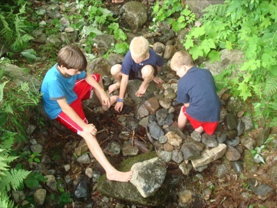 Juniors examine rocks in the stream