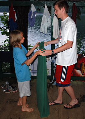 Counselors and campers work together to clean the cabin