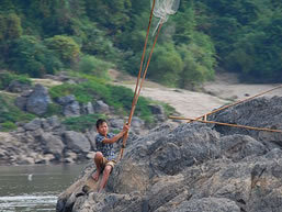 Boy fishing the Mekong River, Laos